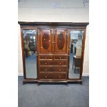A WARING OF LONDON MAHOGANY COMPACTUM WARDROBE, the double bevelled edge mirror doors, flanking