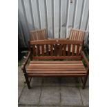 A STAINED TEAK SLATTED GARDEN BENCH, length 119cm, along with a two seater teak garden love seat/