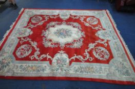 A VERY LARGE CHINESE RED AND CREAM CARPET, 458cm x 365cm (condition report: -in need cleaning due to