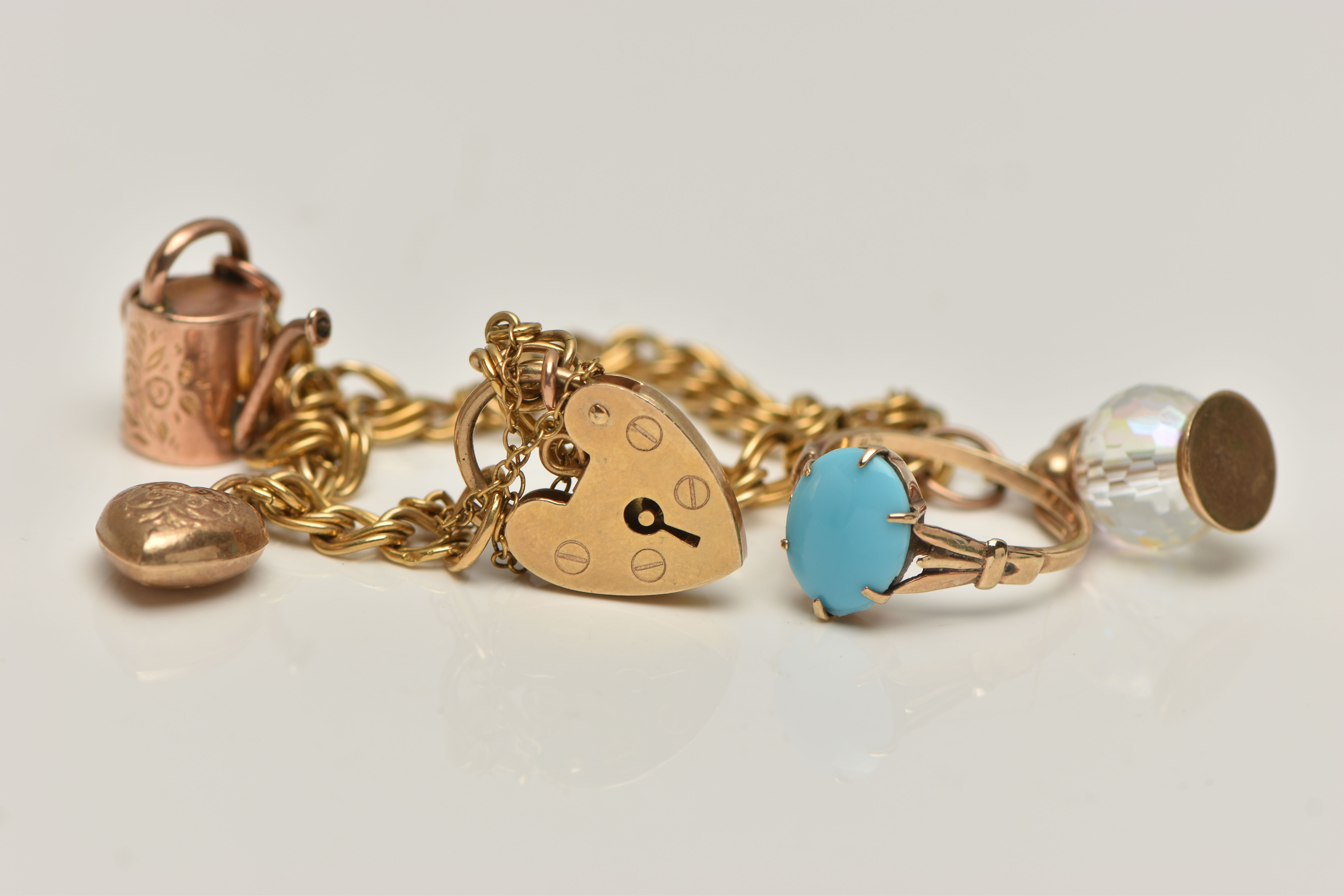 A 9CT GOLD CHARM BRACELET AND A TURQUIOSE RING, double link bracelet, fitted with three charms to