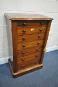 A VICTORIAN MAHOGANY WELLINGTON CHEST OF SEVEN GRADUATED DRAWERS, with turned handles, on a plinth