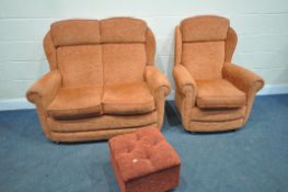 A TWO PIECE ORANGE UPHOLSTERED LOUNGE SUITE, comprising a two seater settee, armchair and a