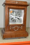 A GERMAN JUNHANS MANTEL CLOCK, with a stepped base, supported by four ball feet, silvered face,