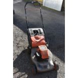 A FLYMO QUICKSILVER 40 PETROL LAWNMOWER, with grass box (condition - engine pulls but then goes