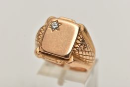 A HEAVY YELLOW METAL DIAMOND SET SIGNET RING, polished rectangular signet set with a single star