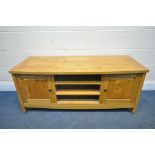 A LIGHT OAK TV STAND, with two fielded panel doors, width 130cm x depth 50cm x height 54cm (