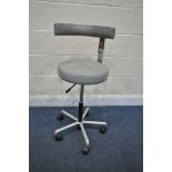 AN ADJUSTABLE SWIVEL DENTAL CHAIR, with grey upholstery, maximum height 91cm x minimum height