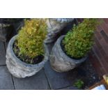 A PAIR OF COMPOSITE CYLINDRICAL TAPERED GARDEN PLANTERS, with scrolled and foliate design,