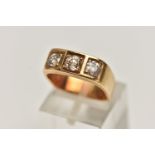 A YELLOW METAL THREE STONE DIAMOND RING, three old cut diamonds, each claw set in a square mount, to