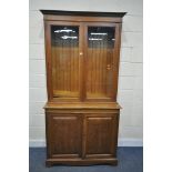 AN EARLY 20TH CENTURY OAK BOOKCASE, with a double glazed top, over fielded panel doors, width