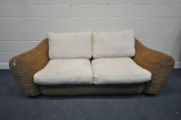 A LARGE WICKER TWO SEATER SOFA, with loose cushions, length 230cm (condition report: -wicker worn in