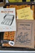 A CASE OF PLASTIC MAH JONG PLAYING PIECES, together with four dice and three instruction manuals (1)