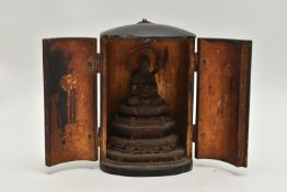 A LATE 19TH CENTURY JAPANESE LACQUER ZUSHI SHRINE, the oval double door cabinet opening to reveal