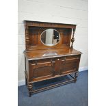 AN EARLY 20TH CENTURY OAK MIRROR BACK SIDEBOARD, with two drawers and cupboard doors, width 138cm