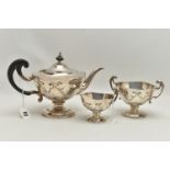 A GEORGE V WALKER & HALL SILVER THREE PIECE PEDESTAL TEA SERVICE, of shaped circular form with cut