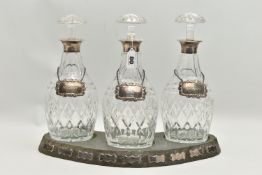 A SET OF THREE ELIZABETH II SILVER MOUNTED CUT GLASS MALLET SHAPED DECANTERS, with mushroom
