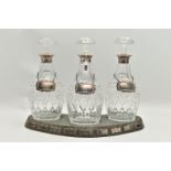 A SET OF THREE ELIZABETH II SILVER MOUNTED CUT GLASS MALLET SHAPED DECANTERS, with mushroom
