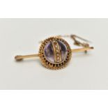 A VICTORIAN BROOCH, principal cabochon amethyst, decorated with a centrally positioned band of