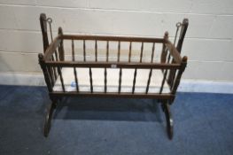 A 20TH CENTURY STAINED BEECH ROCKING CRIB, length 120cm x depth 52cm x height 90cm, and a child’s