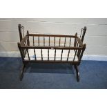 A 20TH CENTURY STAINED BEECH ROCKING CRIB, length 120cm x depth 52cm x height 90cm, and a child’s