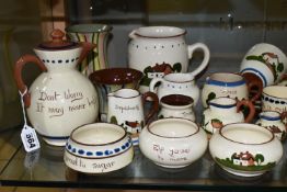 A COLLECTION OF DEVON MOTTO WARE, approximately sixty pieces to include a puzzle jug, a serving