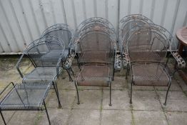 A SET OF FOUR WROUGHT IRON GARDEN CHAIRS, with scrolled armrests depicting foliate designs,