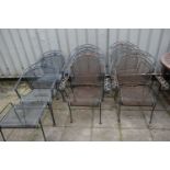 A SET OF FOUR WROUGHT IRON GARDEN CHAIRS, with scrolled armrests depicting foliate designs,
