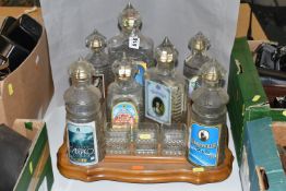 A VINTAGE RUSSIAN SOUVENIR VODKA SET, in the form of The Kremlin, seven stylised empty decanters,