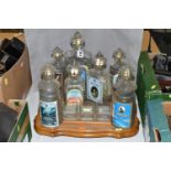 A VINTAGE RUSSIAN SOUVENIR VODKA SET, in the form of The Kremlin, seven stylised empty decanters,