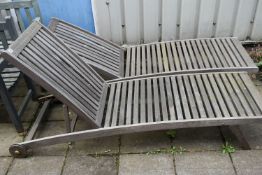 A PAIR OF TEAK SLATTED GARDEN LOUNGERS, length 194cm (condition - one with bolt missing to the