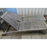 A PAIR OF TEAK SLATTED GARDEN LOUNGERS, length 194cm (condition - one with bolt missing to the