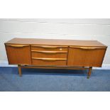 A MID CENTURY TEAK SIDEBOARD, with a fall front door, double cupboard doors that are both flanking