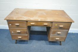 A MID CENTURY TEAK DESK, with seven drawers, width 124cm x depth 61cm x height 75cm (condition