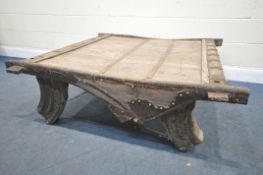 AN MOROCCAN / ANGLO-INDIAN IRON BANDED AND HARDWOOD COFFEE TABLE, on a shaped base, 130cm x depth