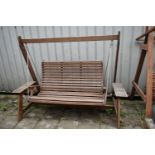 A TEAK GARDEN SWING, with platforms at each end for storage, length 226cm x depth 117cm x height