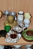 A COLLECTION OF EGG CUPS, twelve examples to include a Holkham pottery green and terracotta egg