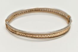 A 9CT BICOLOUR HINGED BRACELET, AF yellow gold textured and pierced centre with white gold edges,