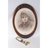 A FRAMED PHOTO OF A FRENCH SOLDIER AND TWO MEDALS, the picture is in a carved wooden frame and