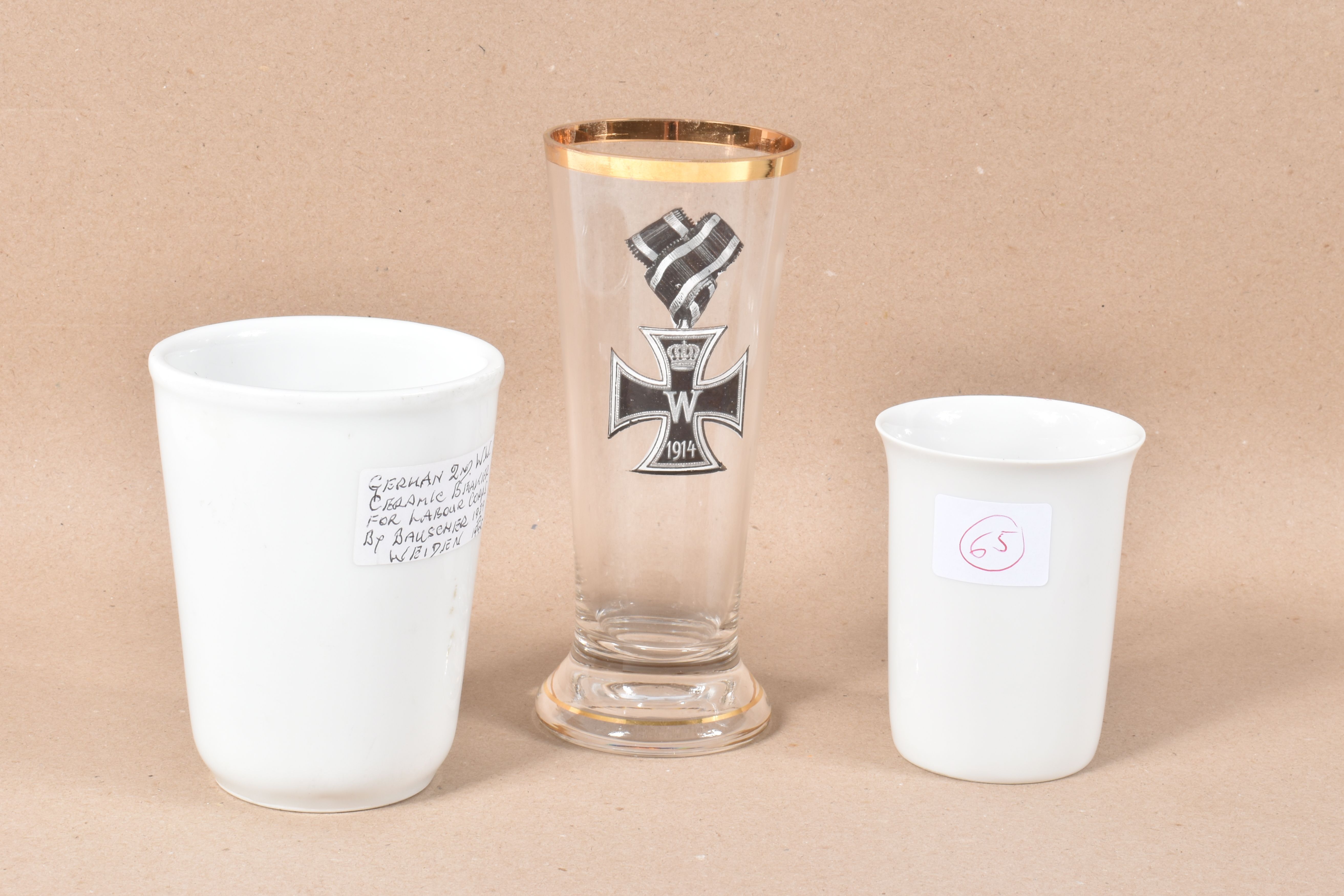 TWO GERMAN WWII WHITE GLAZED CERAMIC BEAKERS AND A LATER DRINKING GLASS DECORATED WITH AN WWI - Image 2 of 8