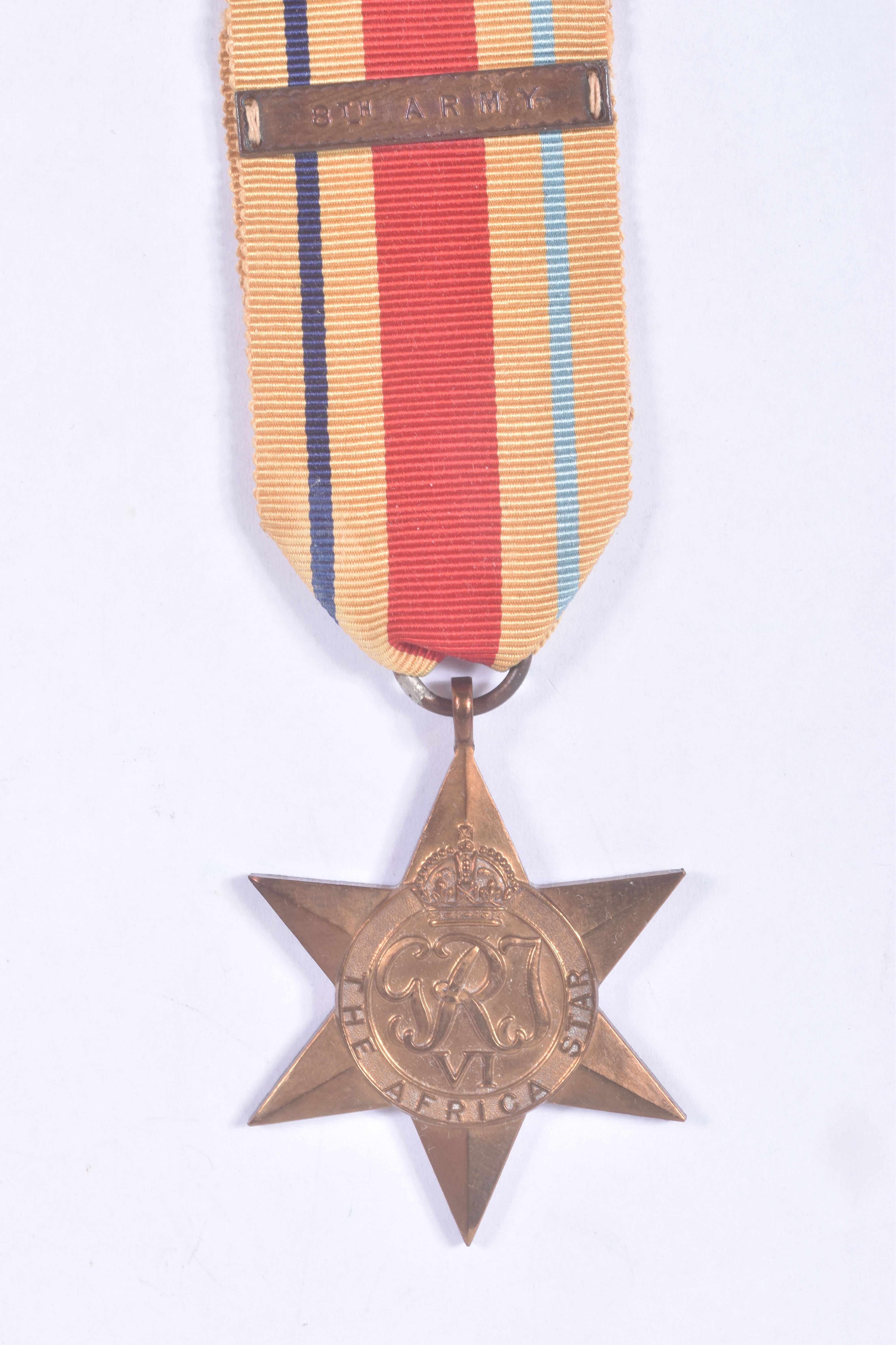 A TIN CONTAINING FOUR WWII MEDALS, a ribbon bar and a cap badge, the medals are all un-named and - Image 7 of 12