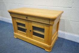 A LIGHT OAK TV CABINET, with a single drawer, and two glazed doors, width 89cm x depth 47cm x height