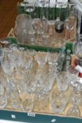 TWO TRAYS OF GLASSWARE, to include four vintage medicine bottles, eleven champagne flutes, decanter,
