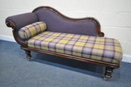 A VICTORIAN MAHOGANY CHAISE LONGUE, with purple and tartan upholstery, on brass caps and casters,