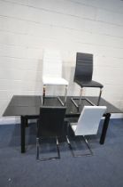 A BLACK GLASS AND METAL EXTENDING DINING TABLE, with a single additional leaf, extended length 210cm
