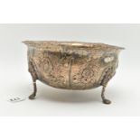 A LATE VICTORIAN SILVER BOWL, with wavy rim, repoussé decorated with foliate scrolls, birds and