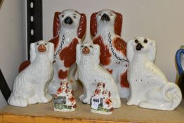 SEVEN STAFFORDSHIRE/STYLE SPANIEL FIGURES, comprising a pair of small spaniel figure groups, each