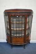 AN EARLY 20TH CENTURY MAHOGANY DEMI LUNE DISPLAY CABINET, with a single door, enclosing two fixed