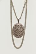 AN OVAL LOCKET, with floral decoration suspended from a curb link chain, length of locket 55mm,