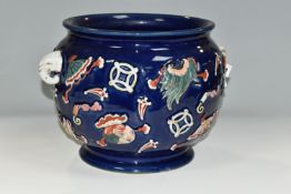 A CHINESE PORCELAIN TWIN HANDLED JARDINIERE, the blue ground with relief moulded with fans, purses