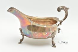 A GEORGE V SILVER SAUCE BOAT, wavy rim S scroll handle on four cabriole legs with hoof feet and